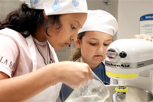 students mixing pizza dough